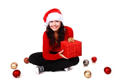 9126-a-beautiful-young-woman-with-a-christmas-gift-on-a-white-background-pv